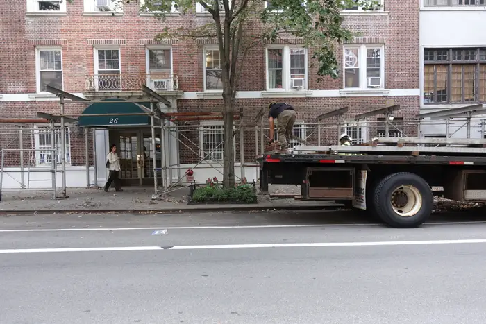 A building in the West Village with a truck parked in front.